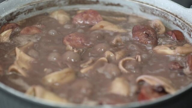 Traditional and irresistible Brazilian feijoada closeup