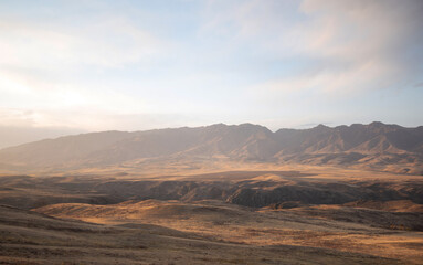 Autumn landscape of vast plains in China. Breathtaking, amazing, endless desert mountain landscapes bordering the Gobi Desert.