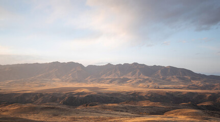 Autumn landscape of vast plains in China. Breathtaking, amazing, endless desert mountain landscapes bordering the Gobi Desert.