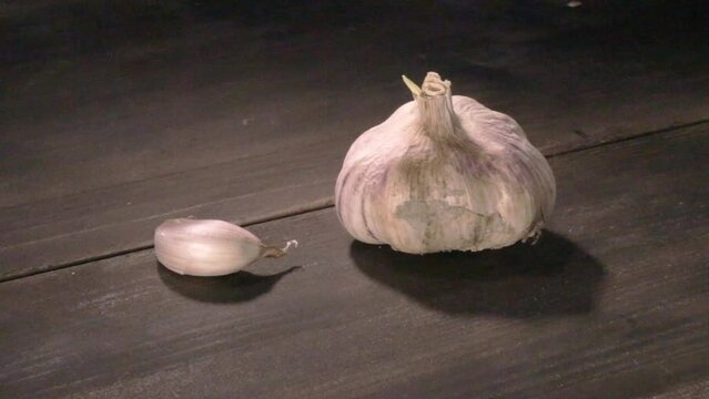 raw garlic on dark table, video