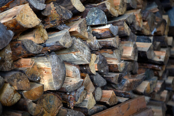 There's firewood in the closet. Stacked firewood. Storage of firewood.