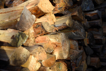 There's firewood in the closet. Stacked firewood. Storage of firewood.