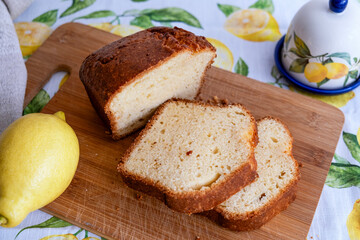 Slices of lemon pie on  wooden board with lemon and lemongrass. A simple recipe for citrus dessert for every day. Homemade baking.