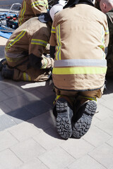 Fireman helping people in damaged car staged training fire fireman at work action