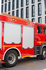 Red firetruck firemen helping people in staged training