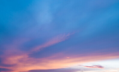 Magnificent purple and orange evening sky clouds. Sunset in tropical country. Blue and pink cloudscape.