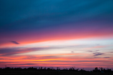Magnificent purple and pink evening sky clouds. Sunset in tropical country. Blue and purple skyscape.