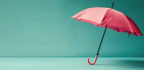 Fototapeta premium Pink Umbrella Hanging on Blue Wall