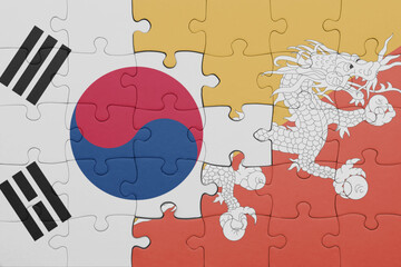 puzzle with the colourful national flag of bhutan and flag of south korea.