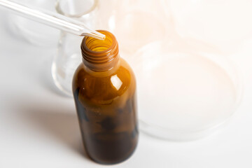 Drops in tea-colored medicine bottles are used in scientific and medical experiments.