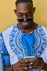 African American Teenager in Traditional Sudanese Attire Engaged with Smartphone