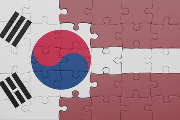 puzzle with the colourful national flag of latvia and flag of south korea.