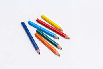 colorful small used pencils on white background