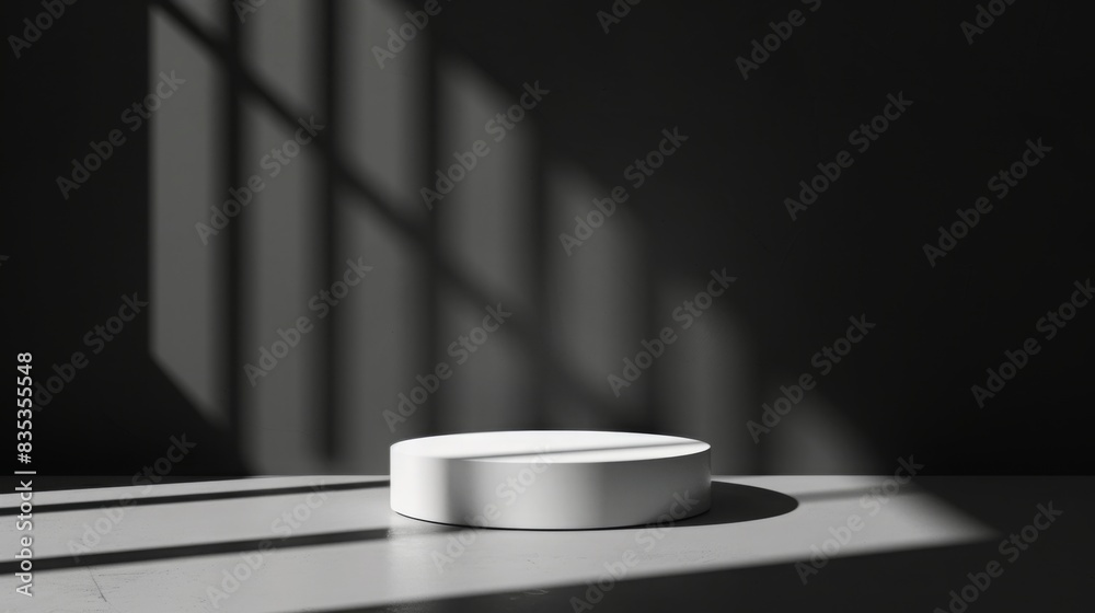 Leinwandbilder A white circular object sits on a surface in a dimly lit room with sunlight streaming through geometric shadows.