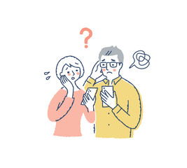 困った顔でスマートフォンを見ているカップル