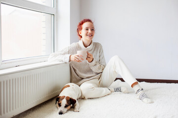 Young Woman Drinking hot coffee at white room