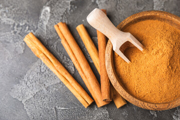Ceylon cinnamon.Cinnamon sticks on a textured wooden background. Cinnamon roll and powder. Spicy spice for baking, desserts and drinks. Fragrant ground cinnamon. Close-up. Place for text. copy space
