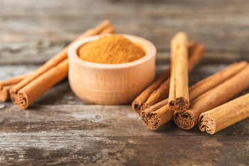 Ceylon cinnamon.Cinnamon sticks on a textured wooden background. Cinnamon roll and powder. Spicy spice for baking, desserts and drinks. Fragrant ground cinnamon. Close-up. Place for text. copy space