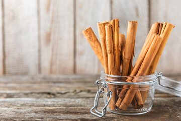 Ceylon cinnamon.Cinnamon sticks on a textured wooden background. Cinnamon roll and powder. Spicy spice for baking, desserts and drinks. Fragrant ground cinnamon. Close-up. Place for text. copy space