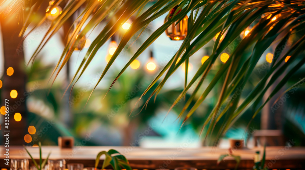 Wall mural blurred background blurred beach bar framed by palm leave