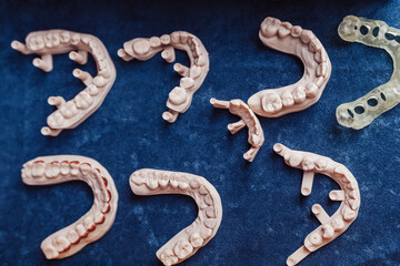 denture teeth on a blue background for elderly people help dentist orthodontist tooth clean