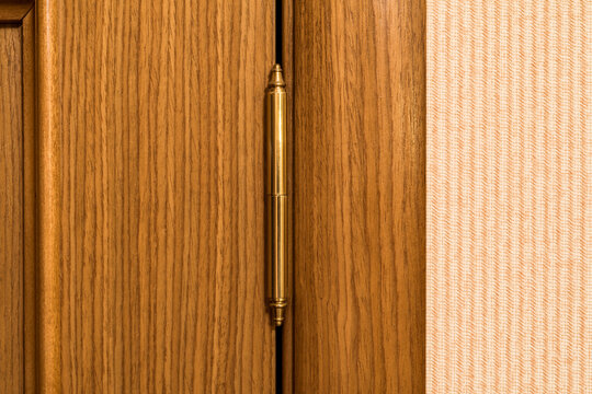 Wooden door. Entrance to the room. Apartment. Door hinge. Classic design. Close-up view.