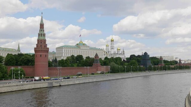 View of the Moscow Kremlin from the Moscow river. Red brick towers and Bell Tower Of Ivan The Great.