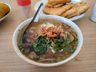 Soto sapi is an Indonesian specialty. It is a soup with a mixture of beef and yellowish-colored soup with a variety of fried onion toppings