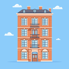 Obraz premium Red Brick Apartment Building on Blue Sky Background
