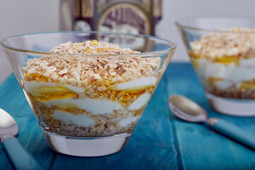 Dishes filled with oatmeal,banana,Greek yogurt and honey.