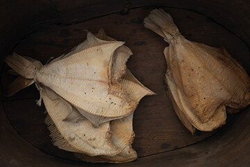 dry fish on a wooden plate