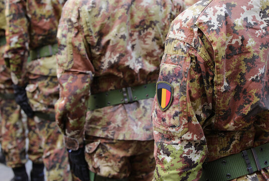 soldier of the Belgian army with the green and brown camouflage uniform and the coat of arms with the flag of Belgium on sleeve