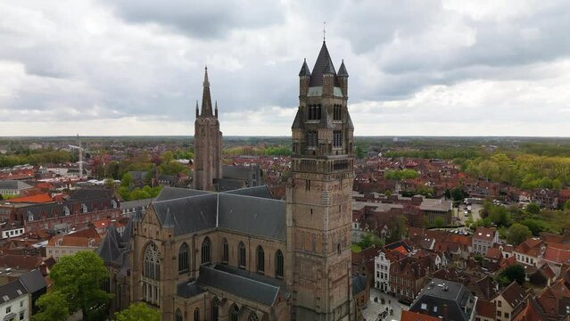 Cathedral Brugges Belgium drone aere&iquest;ial backwards cloudy day