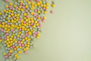 Sweet multi-colored flakes on a colored background. Fast food concept, space for text
