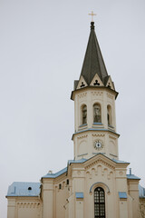Obraz premium Vertical no people shot of Catholic church bell tower exterior in morning, copy space