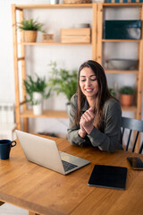 Happy confident businesswoman video calling on laptop, working from home. Smiling female business...