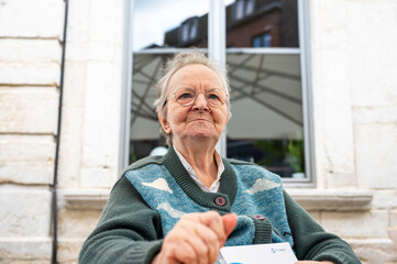 Portrait of an 85 yo white grandmother lookign serious, Tienen, Belgium