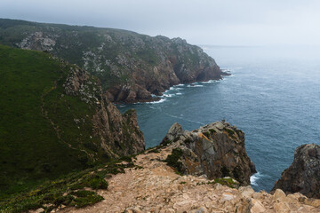 Coastline of Portugal, Cabo da Roca. Cape Roca in Sintra. The lighthouse in Cabo da Roca. Cliffs and rocks on the Atlantic ocean coast. Cloud day
