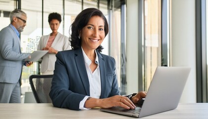 Happy busy mature business woman entrepreneur in office using laptop at work, smiling professional middle aged female company executive manager working looking at computer at workplace