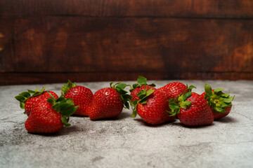 Strawberries on Concrete Table with Dark Wood Background