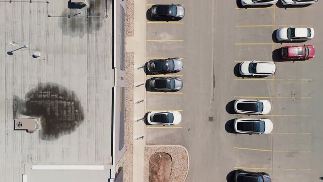 Top View Many cars charging at a Tesla Supercharger station. Supercharger stations allow Tesla cars to be fast-charged at the network within a hour. Dartmouth, Canada.