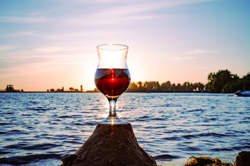 Glass of wine on the beach at sunset