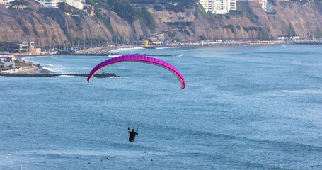 Paragliding over the cliffs of Miraflores in Lima, Peru, offering spectacular views of the Pacific...