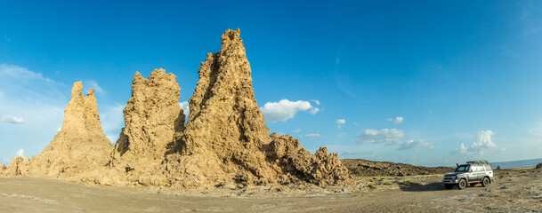 Limestone prehistoric chimneys and offroad vehicle, salt lake Abbe, Dikhil region, Djibouti