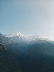 Fototapeta premium clouds over the mountains, mountains in the fog, during annapurna base camp, ghandruk, nepal