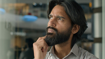 Close-up concentrated pensive thoughtful Indian man male guy businessman creative developer...