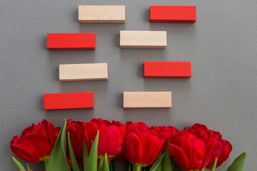 template for cards for birthday, Valentine's Day, Mother's Day, congratulations. Place for text. Red tulips on a gray background.