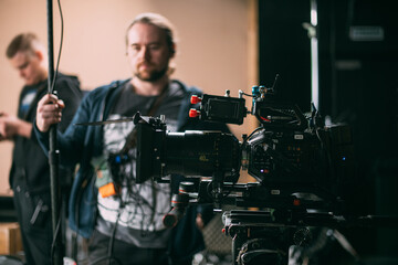 Film set, monitors and modern shooting equipment. Film crew, lighting devices, monitors, playbacks - filming equipment and a team