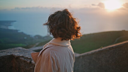 Tourist contemplating sundown landscape at windy weekend closeup. Elegant woman