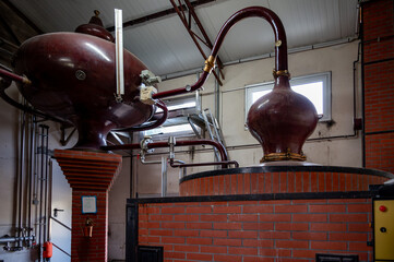 Double distillation process of cognac spirit in Charentias copper alambic still pots and boilers in...